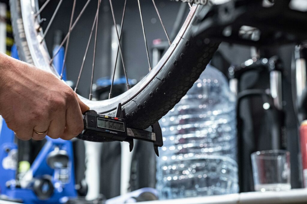 a person holding a bike tire in their hand