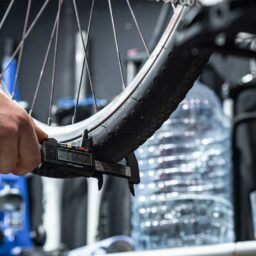 a person holding a bike tire in their hand